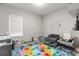 Bright playroom featuring soft carpet, alphabet flooring, and ample space for activities at 6406 Sanctuary Creek Ln, Tampa, FL 33625