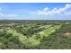 Expansive aerial view of the golf course surrounded by lush green trees and distant city skyline at 6490 Cape Hatteras Ne Way # 4, St Petersburg, FL 33702