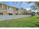 Backyard featuring green grass and a white privacy fence at 6490 Cape Hatteras Ne Way # 4, St Petersburg, FL 33702