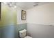 Partial bathroom with toilet and vanity and light colored paint at 6490 Cape Hatteras Ne Way # 4, St Petersburg, FL 33702
