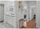 Bright bathroom featuring double sinks and vanity with white cabinets and drawers at 6490 Cape Hatteras Ne Way # 4, St Petersburg, FL 33702