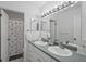 Dual sink bathroom showcasing double vanity, bright lighting, and stylish decor at 6490 Cape Hatteras Ne Way # 4, St Petersburg, FL 33702