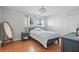 Comfortable bedroom with wood floors, a bed, and ample natural light at 6490 Cape Hatteras Ne Way # 4, St Petersburg, FL 33702