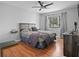 Cozy bedroom with neutral colors, hardwood floors, and a ceiling fan at 6490 Cape Hatteras Ne Way # 4, St Petersburg, FL 33702