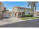 Charming two-story townhome with a two-car garage, well-manicured lawn, and mature palm tree at 6490 Cape Hatteras Ne Way # 4, St Petersburg, FL 33702