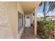 Inviting front porch with tiled flooring, decorative plants, and a white front door adding curb appeal to the home at 6490 Cape Hatteras Ne Way # 4, St Petersburg, FL 33702