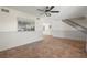 Open living room with tile flooring, decorative lighting, and easy access to the staircase, ideal for entertaining guests at 6490 Cape Hatteras Ne Way # 4, St Petersburg, FL 33702