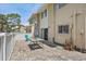 Back patio area complete with chairs, table and a sliding glass door entrance at 6490 Cape Hatteras Ne Way # 4, St Petersburg, FL 33702