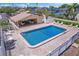 Aerial view of the community pool area with a cabana and surrounding seating at 6490 Cape Hatteras Ne Way # 4, St Petersburg, FL 33702