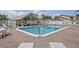 Exterior shot of community pool and cabana area with brick pavers and lounge seating at 6490 Cape Hatteras Ne Way # 4, St Petersburg, FL 33702