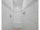 Stylish walk-in shower featuring sleek white tiles and a built-in seat at 6490 Cape Hatteras Ne Way # 4, St Petersburg, FL 33702