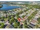 A beautiful aerial view showcases the home near a tranquil lake and a community surrounded by lush greenery at 6933 Waterbrook Ct, Gibsonton, FL 33534
