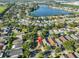 A beautiful aerial view showcases the home near a tranquil lake and a community surrounded by lush greenery at 6933 Waterbrook Ct, Gibsonton, FL 33534