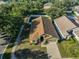 An aerial view shows this cozy home's manicured lawn, welcoming entrance, and comfortable neighborhood at 6933 Waterbrook Ct, Gibsonton, FL 33534