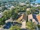 An aerial view shows the home and surrounding neighborhood nestled among mature trees, providing ample shade and privacy at 6933 Waterbrook Ct, Gibsonton, FL 33534