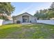 Large backyard featuring a covered patio and a well-maintained lawn, perfect for recreation at 6933 Waterbrook Ct, Gibsonton, FL 33534
