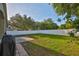 Spacious, partially shaded backyard features a concrete patio and a newer white vinyl fence at 6933 Waterbrook Ct, Gibsonton, FL 33534