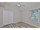Neutral bedroom featuring new floors, a ceiling fan and a window for natural light at 6933 Waterbrook Ct, Gibsonton, FL 33534
