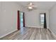 Light-filled bedroom with neutral walls, modern floors, and a sliding glass door with backyard views at 6933 Waterbrook Ct, Gibsonton, FL 33534