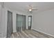 Bright bedroom featuring new gray floors, a ceiling fan and dual windows for natural light at 6933 Waterbrook Ct, Gibsonton, FL 33534