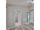 Spacious bedroom with modern gray floors, white trim, and an en suite bathroom at 6933 Waterbrook Ct, Gibsonton, FL 33534