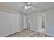 Spacious bedroom with modern floors, ceiling fan, double closet, and ensuite bathroom access at 6933 Waterbrook Ct, Gibsonton, FL 33534