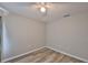 Light bedroom featuring modern gray floors and a ceiling fan with lighting at 6933 Waterbrook Ct, Gibsonton, FL 33534