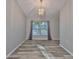 Elegant dining area with hardwood floors, a modern chandelier, and ample natural light at 6933 Waterbrook Ct, Gibsonton, FL 33534