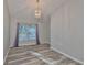 Bright dining area with hardwood floors, a modern chandelier, and large window at 6933 Waterbrook Ct, Gibsonton, FL 33534