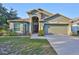 Attractive single-Gathering home with a large front yard and an attached two-car garage at 6933 Waterbrook Ct, Gibsonton, FL 33534
