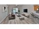 Inviting living room features a cozy sofa, stylish decor, and sliding door to the outside at 6933 Waterbrook Ct, Gibsonton, FL 33534