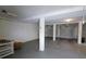 Spacious basement featuring smooth concrete floors and multiple garage doors at 7647 Navigator Ct, Port Richey, FL 34668