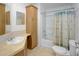 Bathroom with a sink, mirror, and tiled floors, including a tub and shower at 7647 Navigator Ct, Port Richey, FL 34668