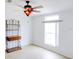Bright bedroom featuring a ceiling fan, shelving unit and window with natural light at 7647 Navigator Ct, Port Richey, FL 34668