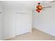 A well-lit bedroom with a ceiling fan and closet at 7647 Navigator Ct, Port Richey, FL 34668