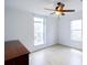 Bedroom with light wood-look floors, ceiling fan, and windows at 7647 Navigator Ct, Port Richey, FL 34668