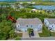 Three-story townhouse with attached garages and a well-maintained front yard in a lush, green setting at 7647 Navigator Ct, Port Richey, FL 34668