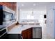 Kitchen with stainless steel appliances, white countertops, wood cabinets, and an open layout at 7647 Navigator Ct, Port Richey, FL 34668
