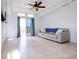 Well-lit living room features tile flooring, white walls, sliding glass doors, and comfortable seating at 7647 Navigator Ct, Port Richey, FL 34668
