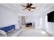 Spacious living room with white walls, tile flooring, modern ceiling fan, and natural light at 7647 Navigator Ct, Port Richey, FL 34668
