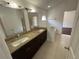 Bathroom featuring a double sink vanity with granite countertop and separate bathtub and shower area at 8908 Southbay Dr, Tampa, FL 33615