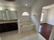 A full bathroom features a luxurious bathtub, double sink vanity, and a bright window at 8908 Southbay Dr, Tampa, FL 33615