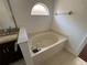 A relaxing bathtub with tiled surround and a convenient hand-held shower faucet at 8908 Southbay Dr, Tampa, FL 33615