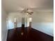 Spacious bedroom with dark wood floors and multiple doorways and closets at 8908 Southbay Dr, Tampa, FL 33615