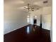 Main bedroom has dark wood flooring, ceiling fan, and an ensuite bathroom at 8908 Southbay Dr, Tampa, FL 33615