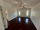 Large bedroom with dark hardwood floors, ceiling fan, and two sunny windows at 8908 Southbay Dr, Tampa, FL 33615