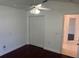 Spacious bedroom featuring a ceiling fan, closet and warm, wood-look floors at 8908 Southbay Dr, Tampa, FL 33615