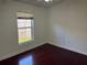Bedroom featuring hard wood floors, window, and neutral colored walls at 8908 Southbay Dr, Tampa, FL 33615