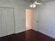 Bright bedroom with hard wood floors and doorway leading to the en suite at 8908 Southbay Dr, Tampa, FL 33615