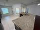 Kitchen with granite counters, breakfast bar, stainless sink, and tile flooring at 8908 Southbay Dr, Tampa, FL 33615